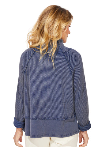 Woman wearing a blue textured jacket on a white background