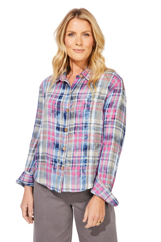 Woman wearing a plaid shirt against a white background