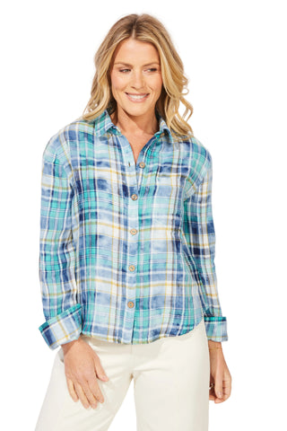 Woman wearing a blue plaid shirt against a white background