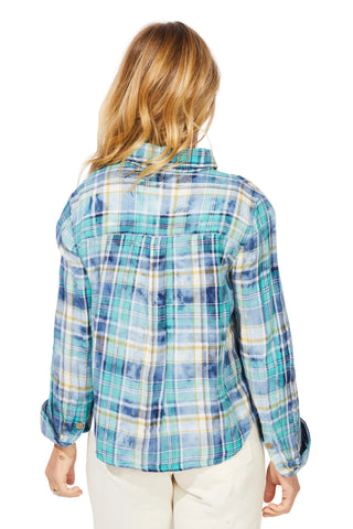 Person wearing a blue and green plaid shirt on a white background
