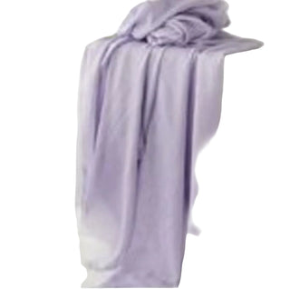 Purple towel draped over a white surface with a blurred background