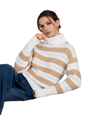 Woman wearing a white and beige striped sweater sitting on a brown leather couch.