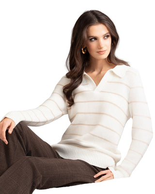 Woman wearing a white sweater sitting on a light gray background