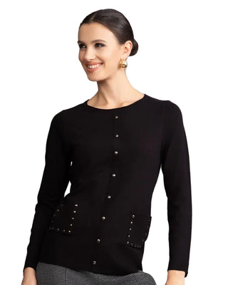 Woman wearing a black long-sleeve top with button details against a gray background