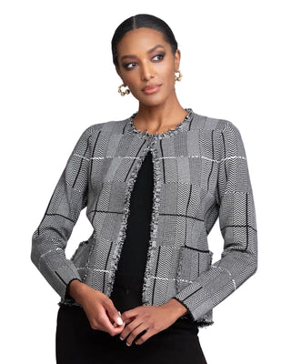 Woman wearing a patterned gray jacket against a plain background