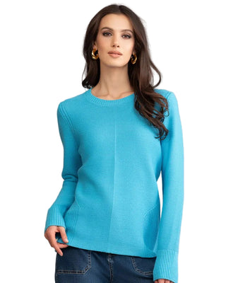 Woman wearing a blue sweater against a neutral background