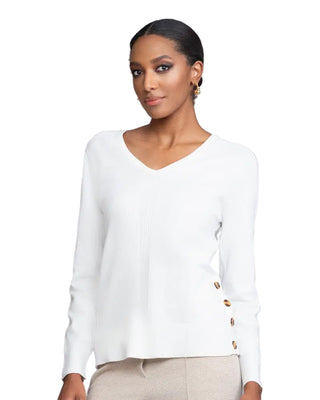 Woman wearing a white long-sleeve top with buttons on a light gray background