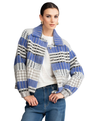 Woman wearing a blue and gray plaid jacket on a white background