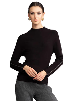 Woman wearing a black long-sleeve top with white trim against a gray background