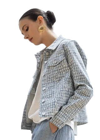 Woman wearing a patterned jacket with a plain background