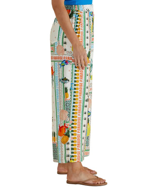 Colorful patterned pants worn by a person on a beige background
