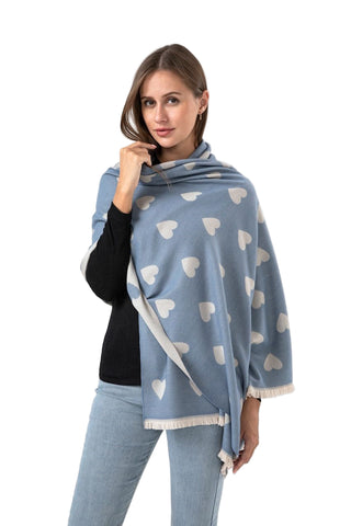 Woman wearing a blue pashmina with heart patterns on a white background