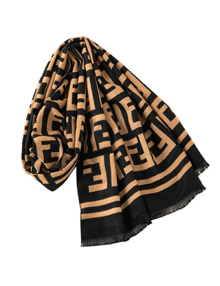 Black and beige patterned scarf on a white surface