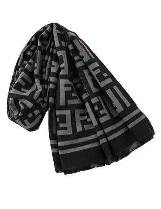 Black and gray patterned scarf on a white surface