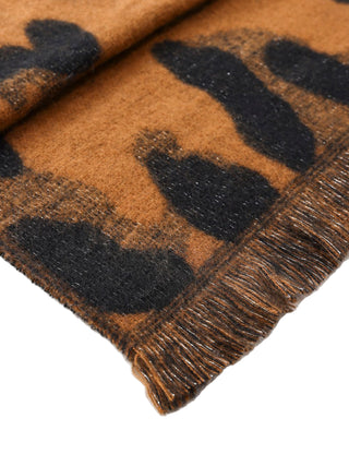 Close-up of a brown and black checkered fabric with fringed edge on a white background