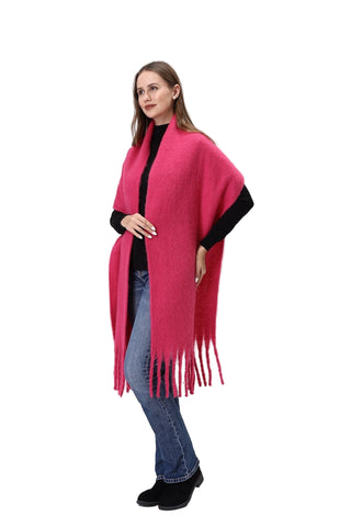 Woman wearing a bright pink scarf with black edges on a white background