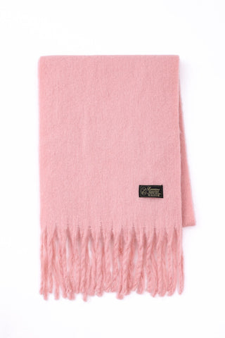 Pink scarf with a brand label on a white background
