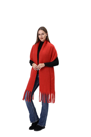 Woman wearing a red scarf with fringe on a white background