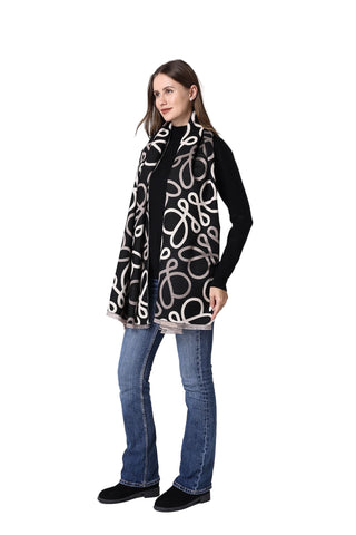 Woman wearing a black and white patterned scarf on a white background