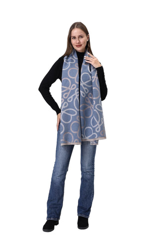 Woman wearing a patterned scarf, black shirt, and blue jeans on a white background