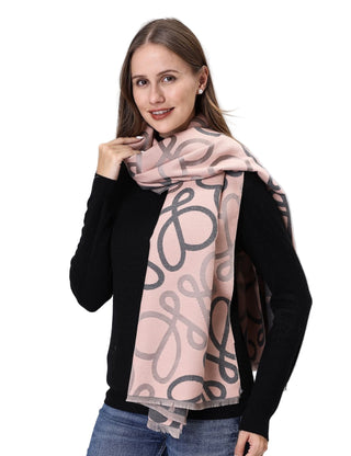 Woman wearing a pink scarf with a black pattern on a white background