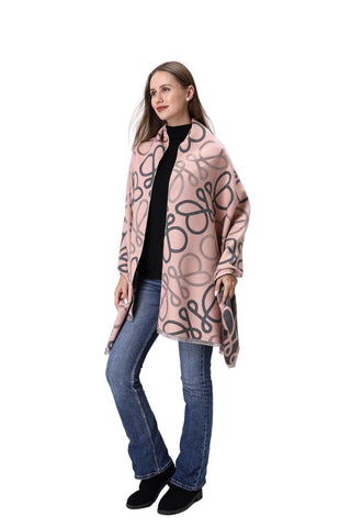 Woman wearing a patterned pink coat on a white background