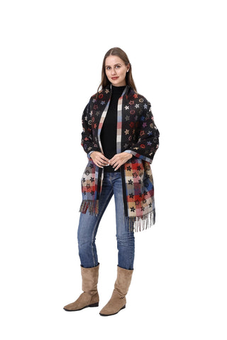 Woman wearing a patterned scarf, black top, jeans, and brown boots on a white background