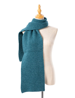 Teal knitted scarf on a mannequin against a white background