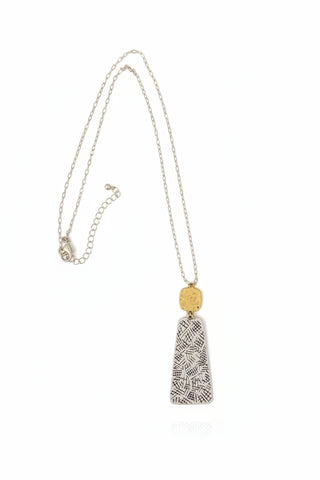 Necklace with a pendant on a textured surface