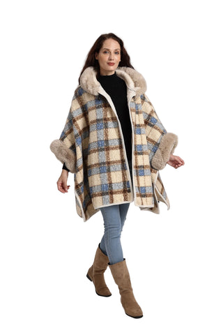 Woman wearing a plaid coat with fur trim on a plain background