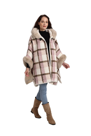 Woman wearing a plaid coat with fur trim on a white background