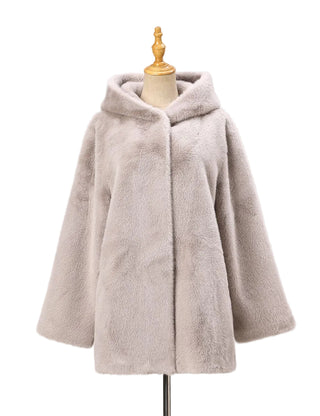 Beige fleece cape on a mannequin against a white background