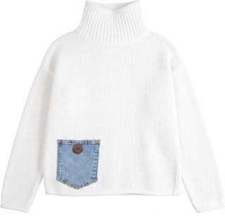 A white ribbed knit turtleneck sweater with a front pocket made from light blue denim, featuring a brown button closure, shown against a plain white background.