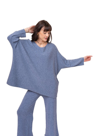 Woman wearing a blue outfit against a white background