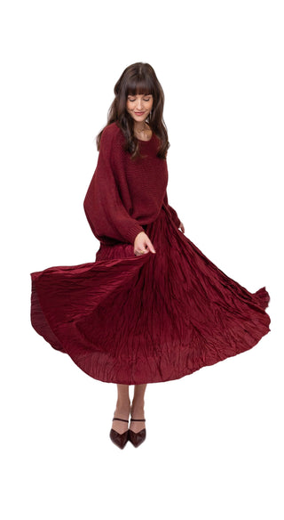 Woman wearing a burgundy dress on a white background