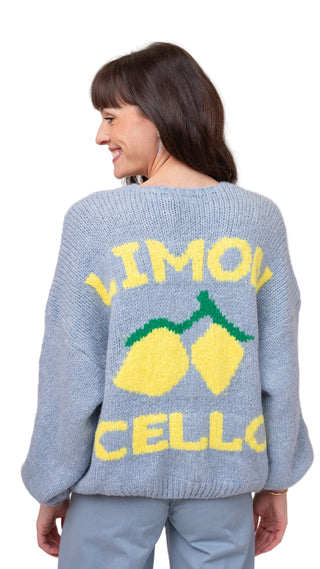 Person wearing a blue sweater with 'Limoncello' text and lemon graphics on a plain background