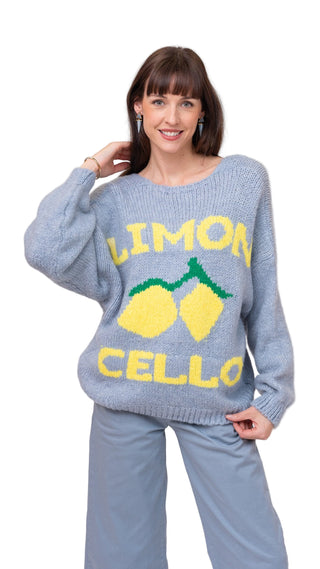Woman wearing a light blue sweater with 'Limon Cello' text and lemon graphics on a plain background