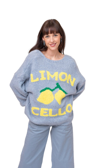 Woman wearing a gray sweater with 'Limon Cello' text and lemon graphics on a plain background