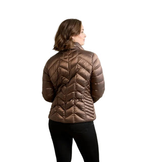 A woman shown from the back wearing a brown quilted puffer jacket and black pants, standing against a plain light gray studio background.