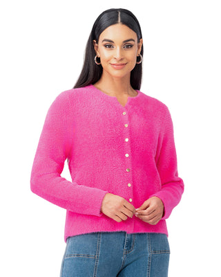 Woman wearing a bright pink cardigan against a white background