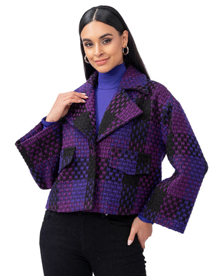 Woman wearing a patterned purple jacket against a white background