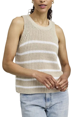 Woman wearing a beige and white striped sleeveless top against a plain background