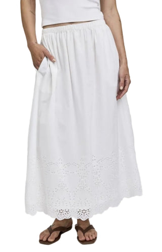 White skirt with lace details worn by a person on a white background