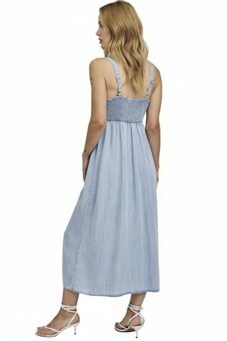 Woman wearing a light blue dress with a white background