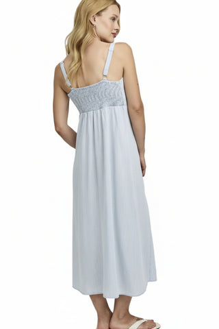Woman wearing a light blue dress with a white background