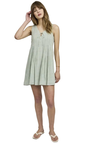 Woman wearing a green checkered dress on a white background
