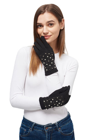 Woman wearing black gloves with star embellishments on a light gray background