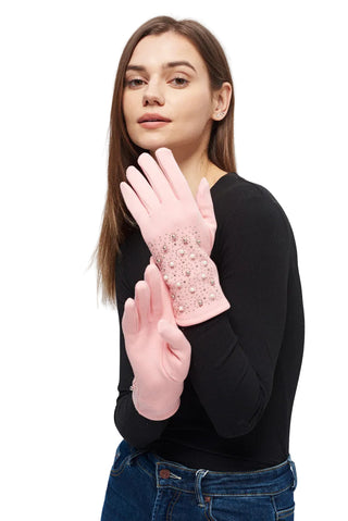 Woman wearing pink gloves with lace detailing on a plain background