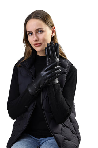 Woman wearing black leather gloves against a white background
