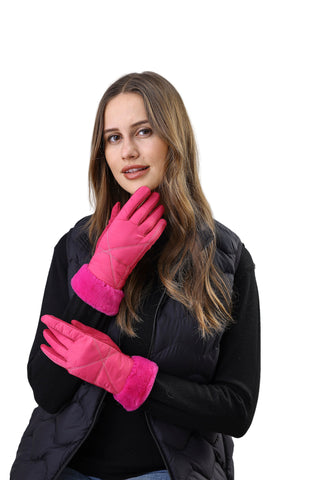 Woman wearing pink gloves and a black coat against a white background